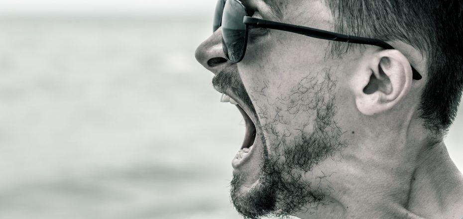 portrait of a man, the cry of a man in sunglasses closeup black and white photo